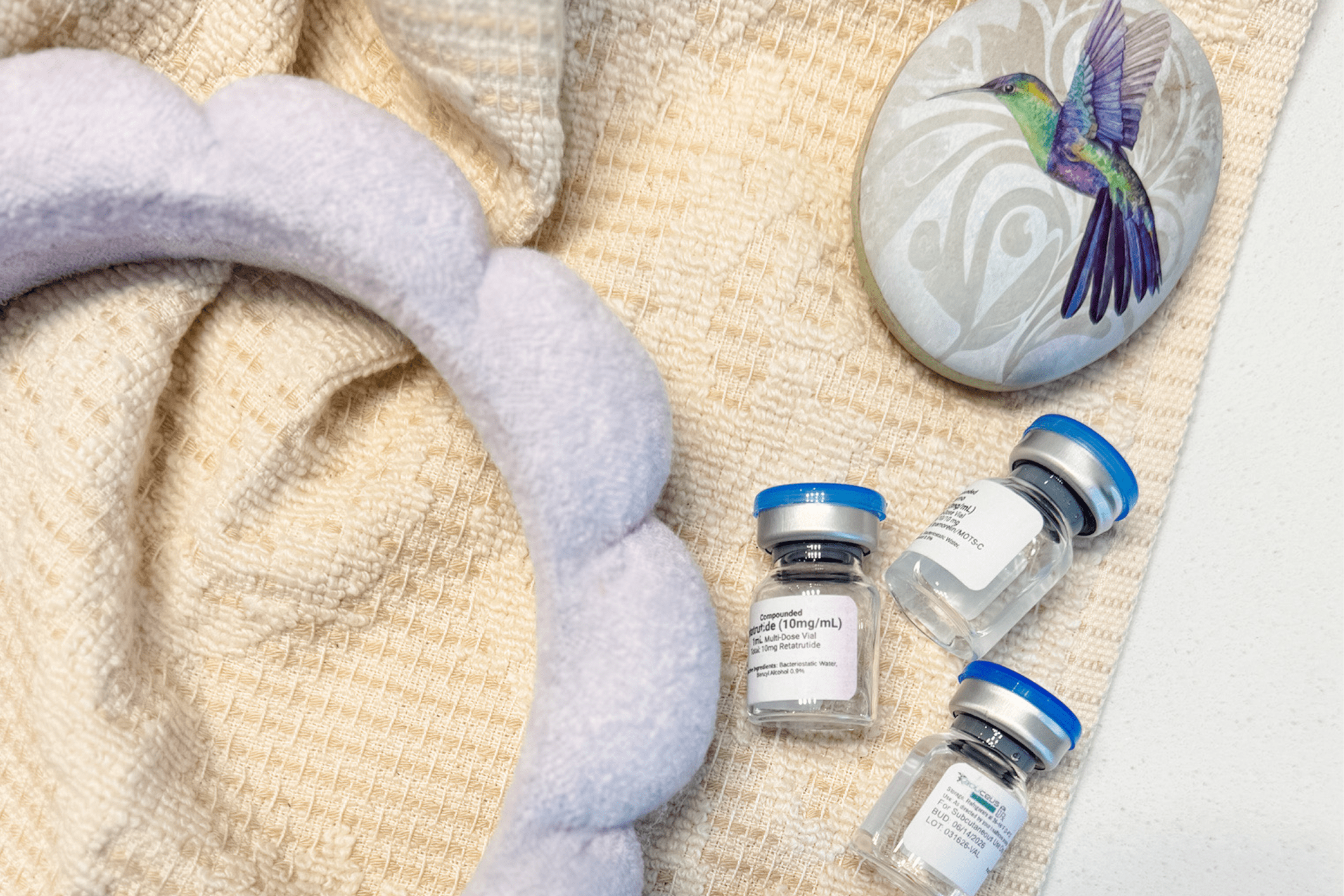 Vials on blanket with decorative stone.