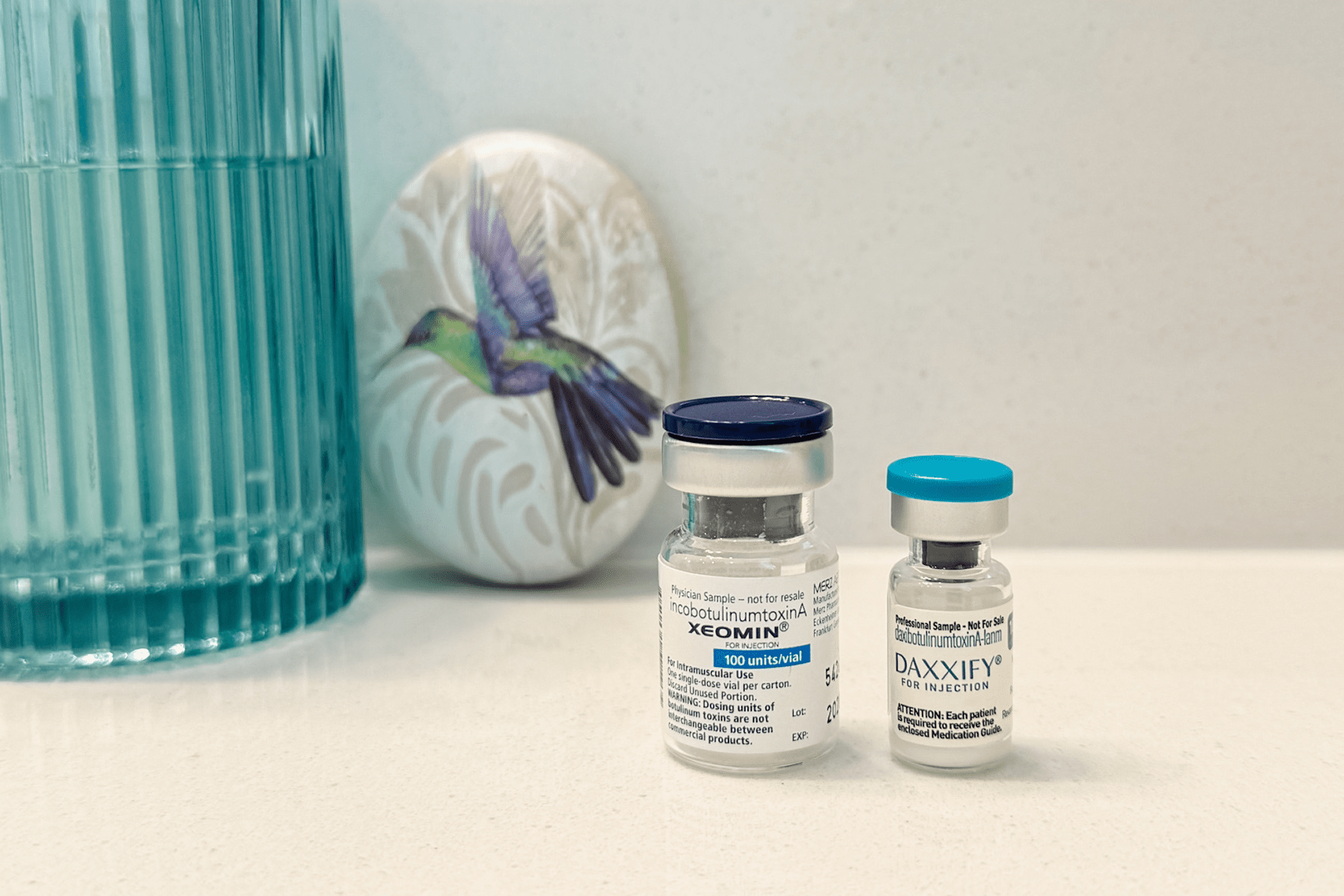 Two medicine vials on a countertop.